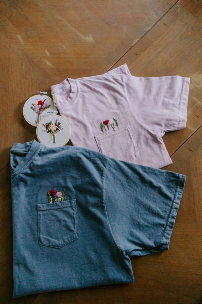 Embroidered birth flower pocket teas, and hoops on table.