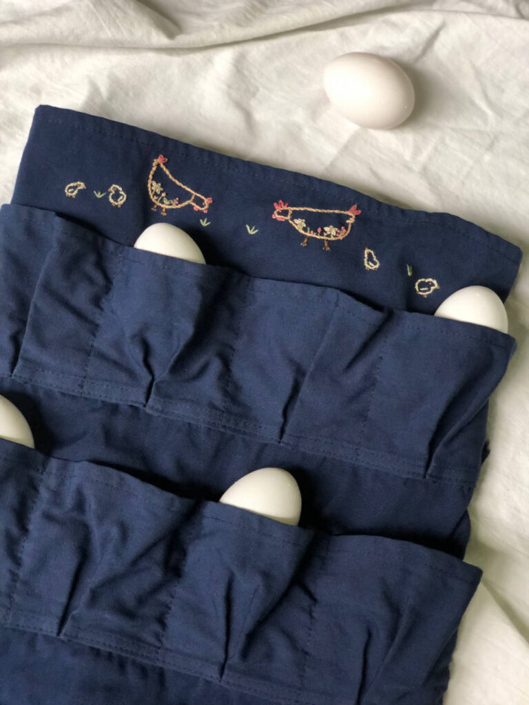egg-collecting apron with embroidered chickens