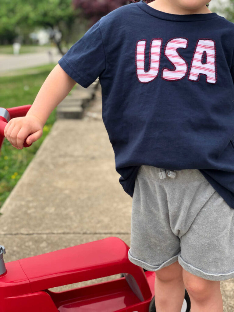 little boy wearing "USA" reverse applique shirt