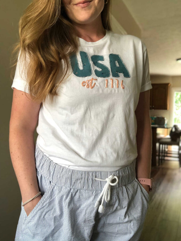 woman wearing USA reverse applique embroidered shirt