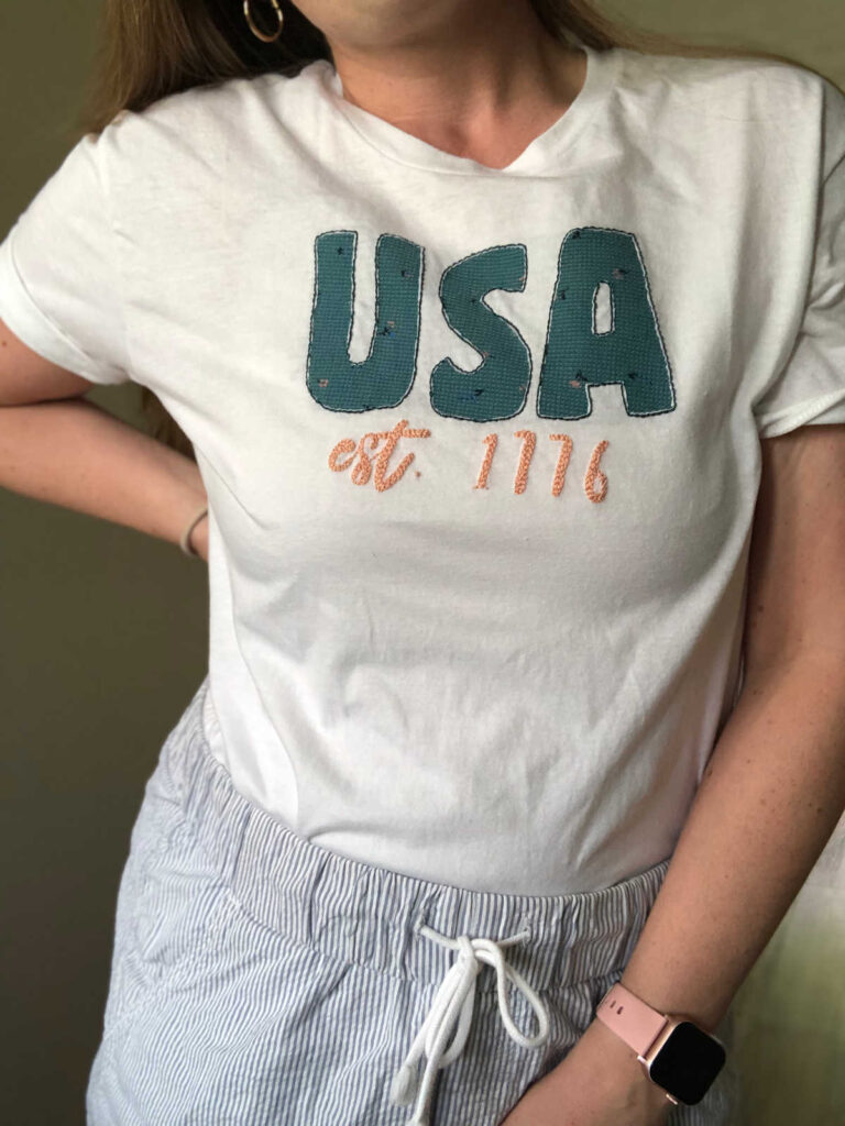 woman wearing USA reverse applique embroidered shirt